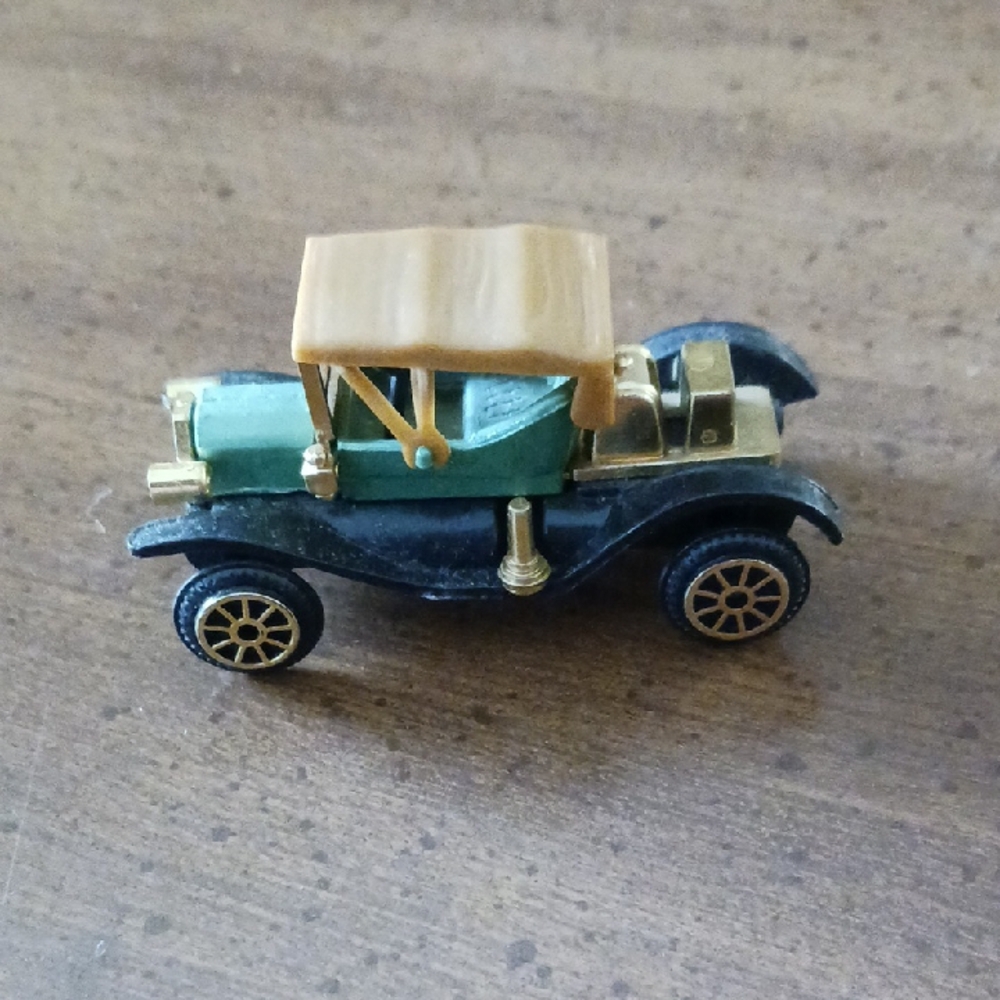 Green and Gold Vintage Toy Car with Intricate Detailing